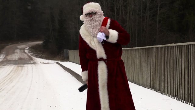 Santa Claus with beer bottle on the bridge