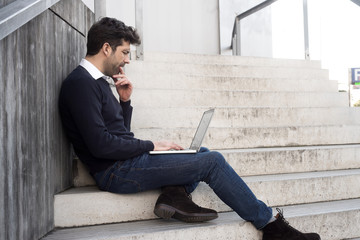 young man with computer and doubts