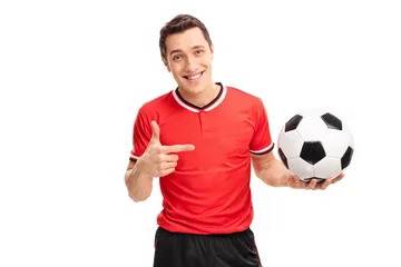 Foto op Plexiglas Football player holding a ball and pointing to it © Ljupco Smokovski