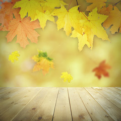 Naklejka na ściany i meble Autumnal leaves with bokeh and wooden floor. Beautiful natural autumnal background