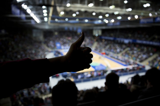 Thumps up silhouette at basketball game 