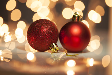  Two red christmas balls with blurred light background