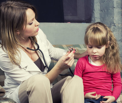 Young Doctor With Little Girl Patient Feeling Bad Medical Inspec