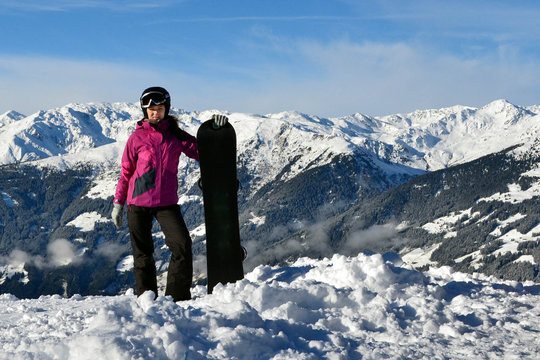 A girl with a black snowboard