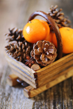 New Year's basket with tangeriness and pine cones
