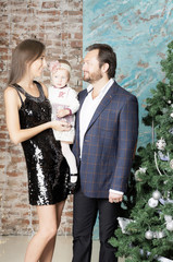 Family portrait near the Christmas tree. Christmas family portrait around the Christmas tree.