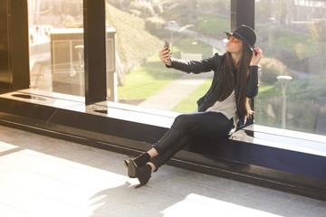 Young beautiful woman taking a selfie in the city