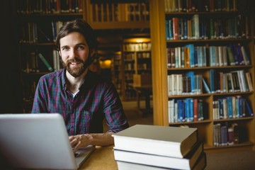 Hipster student studying in library