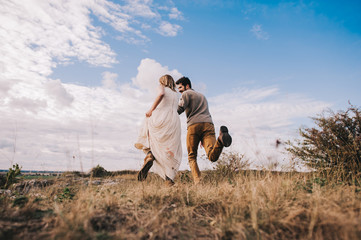 Fototapeta premium couple in the field near the mountains