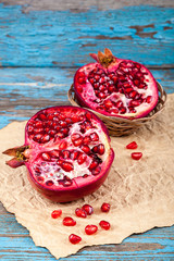 Fresh pomegranate on wooden boards.