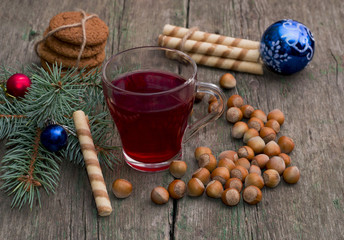 coniferous branch with Christmas tree decorations, tea, sweets a