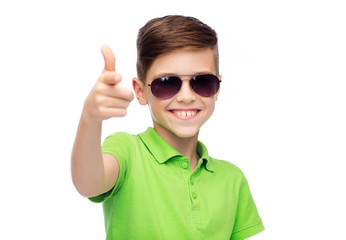 smiling boy in sunglasses and green polo t-shirt