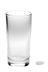 aspirin pills and empty glass isolated on white