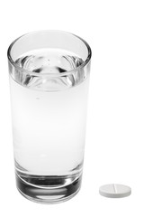 aspirin pills and glass of water isolated on white