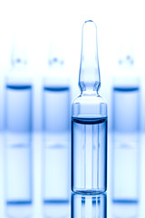 Different medical ampoules on blue background