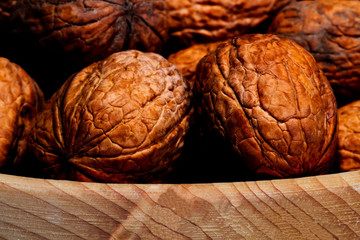 walnuts in a wicker basket on white background closeup
