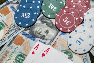 Poker chips, playing card and dollar bills background