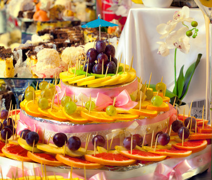 Sliced fruits and sweets for wedding table