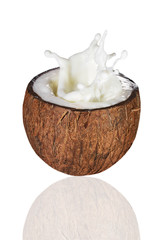 Coconut in milk splash, isolated on white background