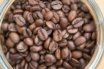 Coffee beans in a glass bowl. Shallow dof