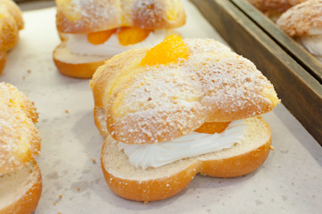 Choux cream sweet with orange on top