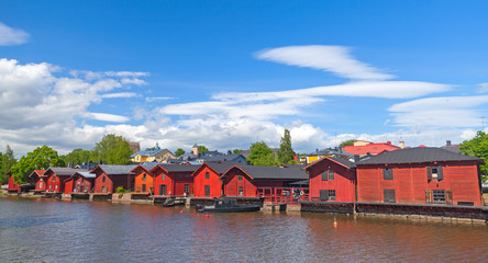 Fototapeta na wymiar Old red houses on the river coast in Porvoo