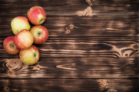 red apples on the brown wooden background