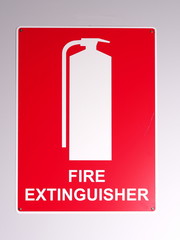 Emergency fire extinguisher wall sign in red on off white background on a wall, Australia 2015
