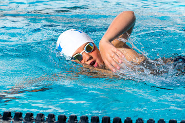 Close up action shot of teen swimmer.