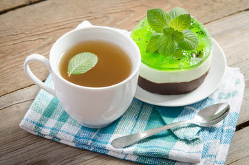 herbal tea with cake on wooden background.