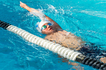 Teen backstroke swimmer in action.