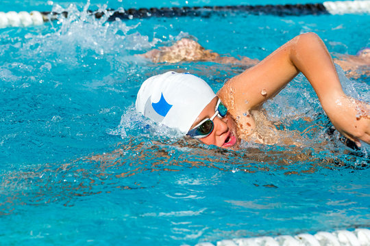 Young male swimmer competing in gala.