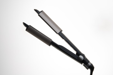 Hair straighteners grey and black  isolated on white background