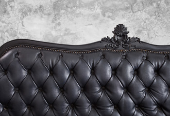 Black leather backrest background and concrete wall