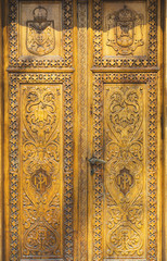 Fototapeta na wymiar Beautiful ornately carved wooden door