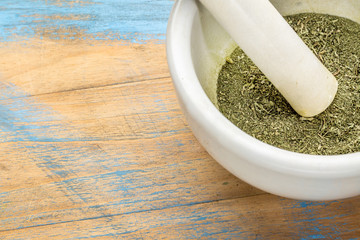 stevia leaves crushed in mortar