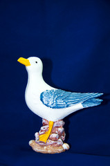Trinket seagull isolated on the blue background
