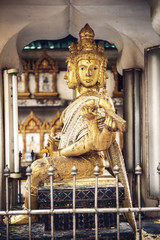 Fototapeta na wymiar Phra Phrom statue in Bangkok a street. Phra Phrom is the Thai re