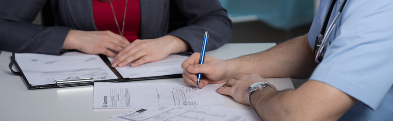 Docotr writing prescription for patient