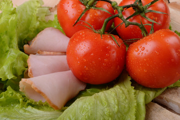 Bunch of tomatoes, ham and green salad