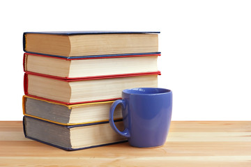 Fototapeta na wymiar A stack of books and a Cup on table, on a white background.