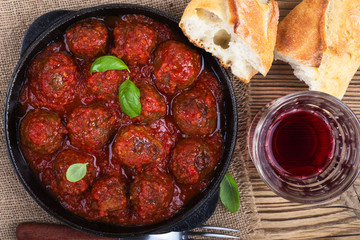 Homemade meatball in frying pan on  rustic wooden table,top view
