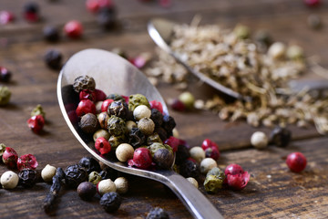 spoon with a variety of peppercorns