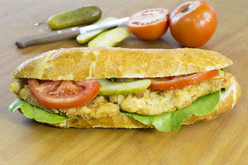 Delicious Chicken Sandwich With Fresh Vegetable on Wooden Table