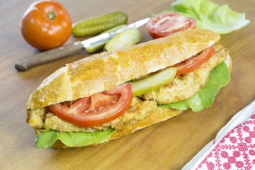 Delicious Chicken Sandwich With Fresh Vegetable on Wooden Table