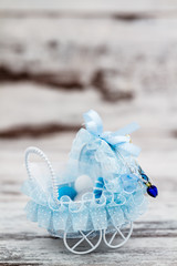 Obraz na płótnie Canvas Blue Toy Baby Carriage Prepared as a Gift for Baby Shower