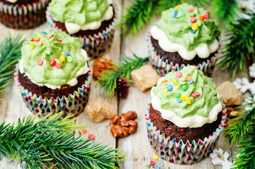 Chocolate cupcakes with green frosting and sprinkles on holiday