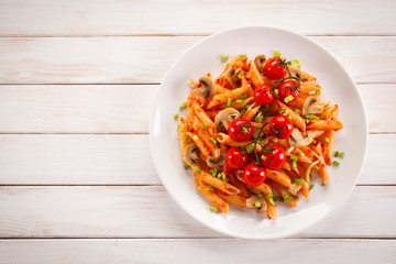 Penne with meat, tomato sauce and vegetables