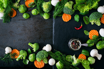 Fresh vegetables for a healthy diet on a dark background in a rustic style. Vegetarian food. Top view