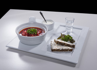 Ukrainian red borscht with salo sandwiches on ceramic tray 